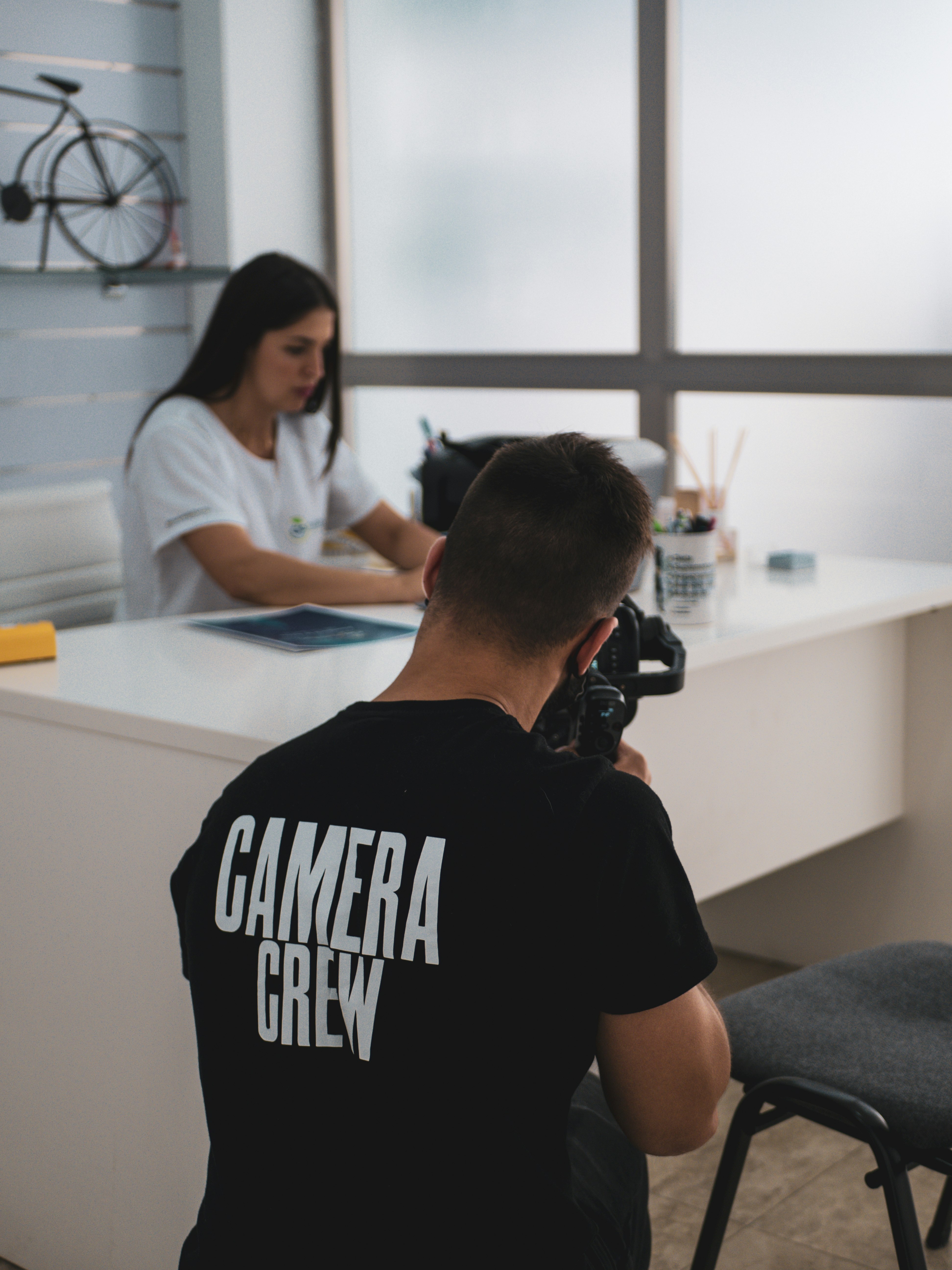 man in black crew neck t-shirt sitting on chair